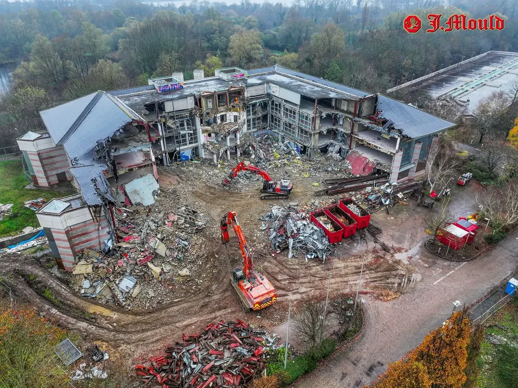 Aerial view of a J.Mould demolition site with excavators clearing rubble