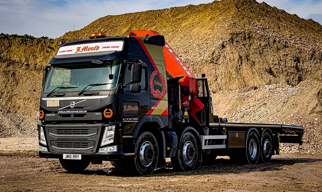J Mould HIAB lorry parked beside an aggregate stockpile