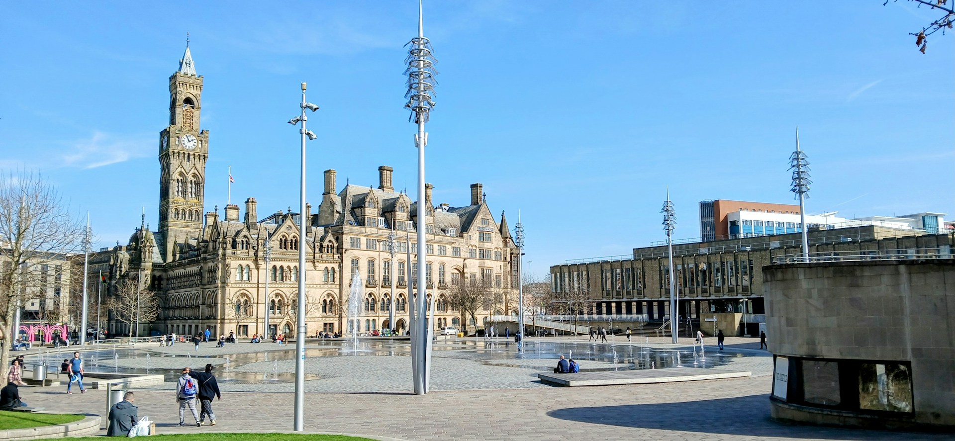 Bradford City Hall clock tower over the City Park mirror pool, where J Mould carries out demolition