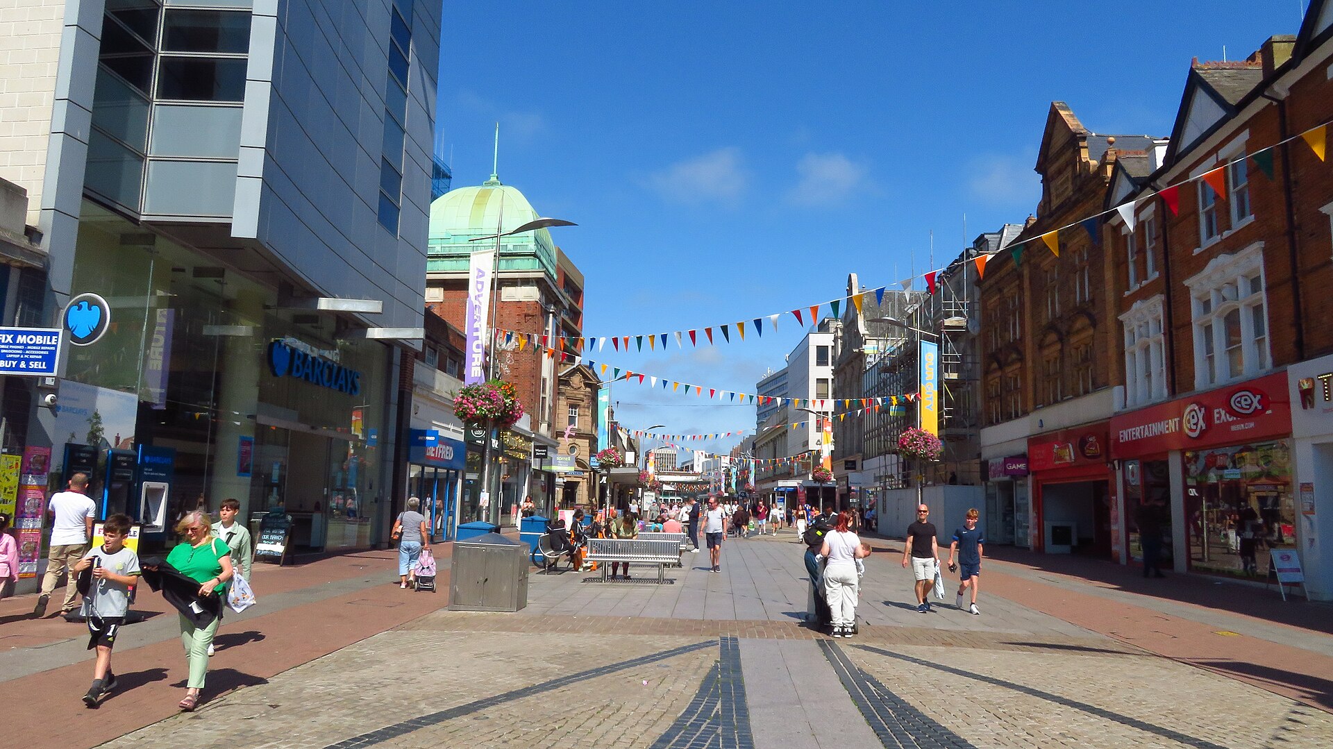 Southend-on-Sea High Street under colourful bunting, where J Mould carries out demolition