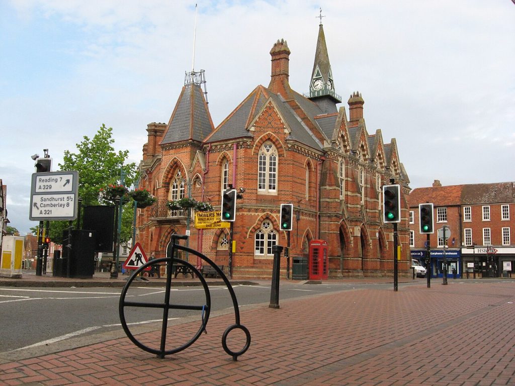 Wokingham's red-brick Victorian town hall and a road sign to Reading, an area J Mould covers