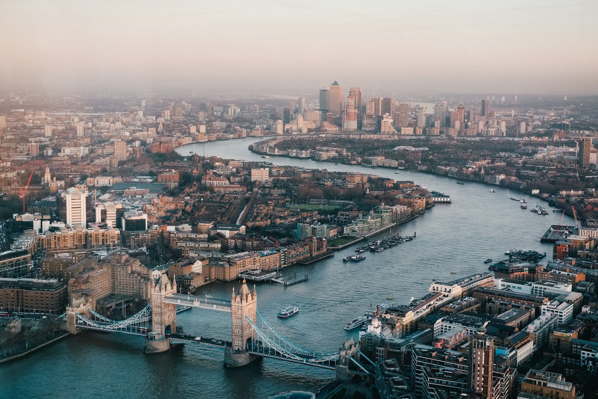 Aerial view of Tower Bridge and the River Thames towards Canary Wharf, where J Mould carries out demolition