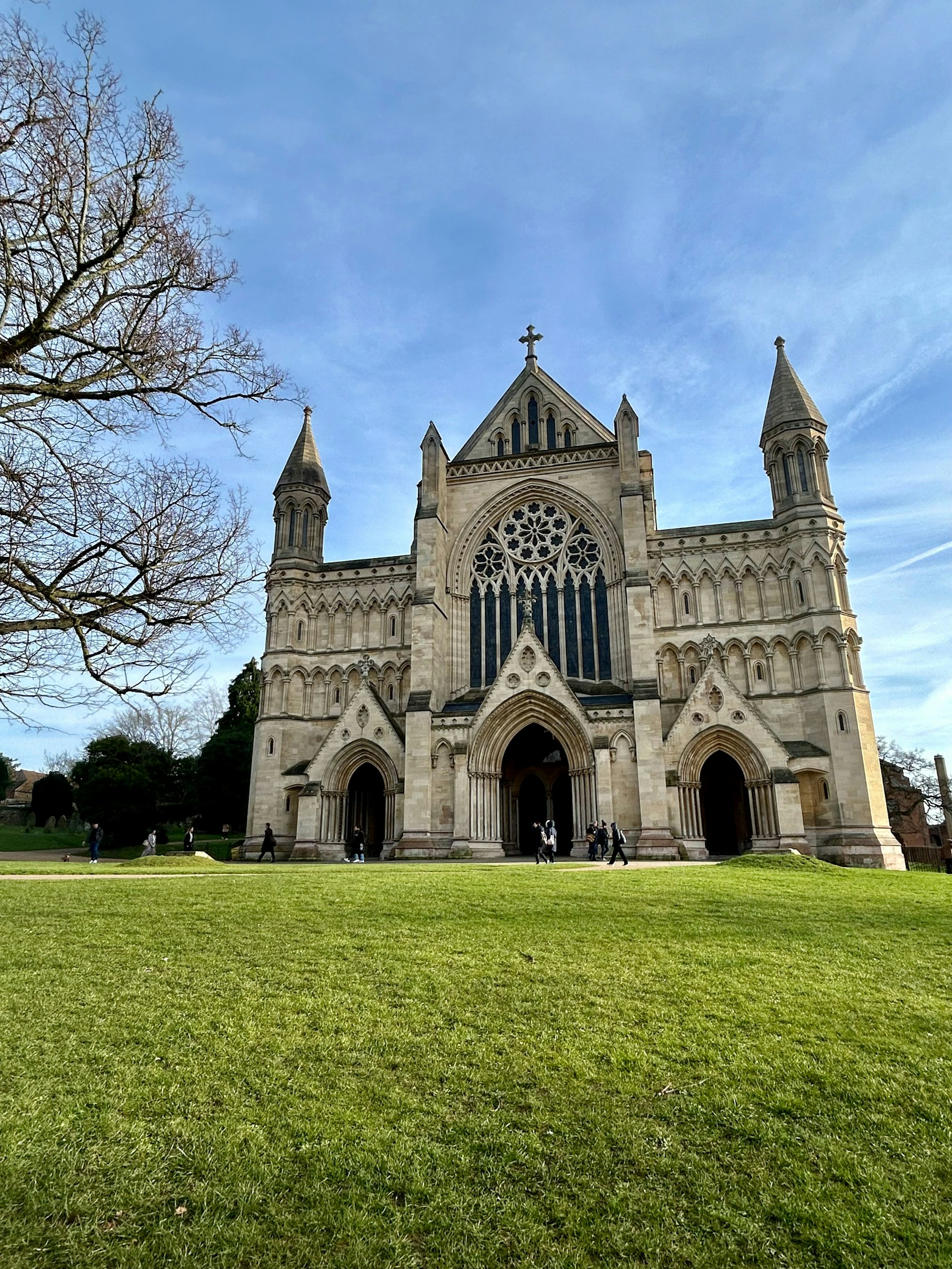 West front of St Albans Cathedral across the lawn, where J Mould carries out demolition