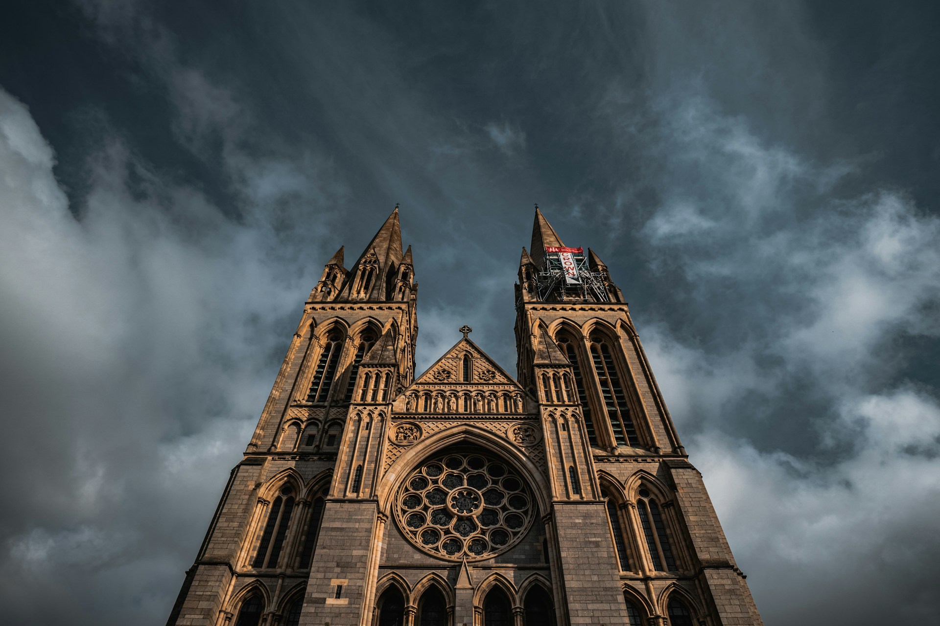 West front of Truro Cathedral under a stormy sky, a city J Mould covers for demolition